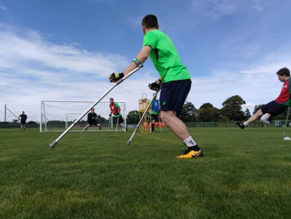 Amputee footballers practising with the new Belfast Amputee Football Club