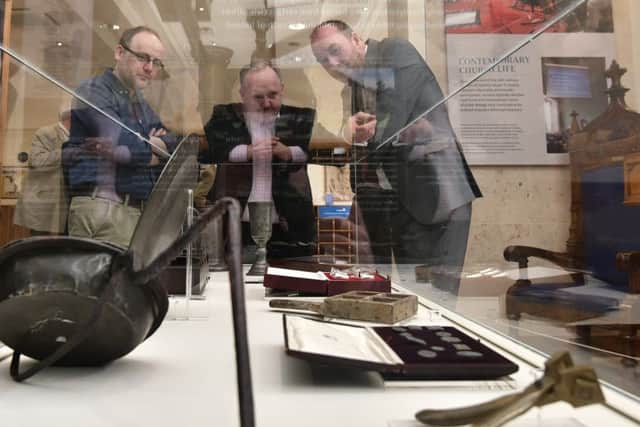 Guests at the opening of the Presbyterian Church in Ireland's new visitor exhibition in Belfast city centre check out some of the artefacts on display. 
Photo: Colm Lenaghan/Pacemaker Press