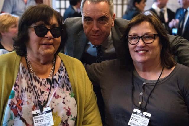 Actor James Nesbitt (centre) poses for a photograph with Margaret Yeaman (left) and Jennifer McNern, two women who were injured during the Troubles in Northern Ireland, at the launch of the Injured On That Day photography exhibition, featuring men and women who were severely injured during the conflict in Northern Ireland