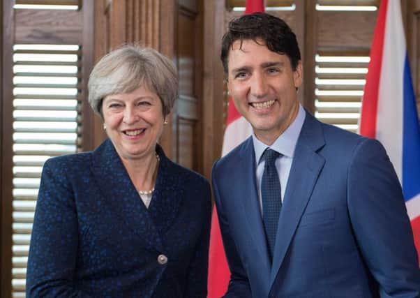 Prime Minister Theresa May talking with Canadian Prime Minister Justin Trudeau in his office on Parliament Hill in Ottowa in 2017. Photo: Stefan Rousseau/PA Wire
