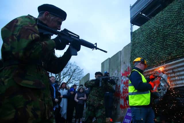 'Border Communities Against Brexit' came together on the old Dublin Road outside Newry where they staged a protest on 26 January. Protestors with replica weapons pretending to be British soldiers took part, while a mock British army checkpoint was dismantled. 
Picture by Jonathan Porter/PressEye