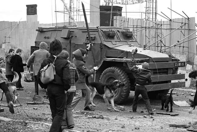 Youths bombarding an army Saracen at a junction on the Whiterock Road in Belfast in 1980. Photo: Pacemaker.