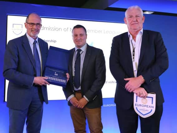 NI Football League managing director Andrew Johnston (centre) and chairman Brian Adams (right) are presented with a certificate of membership by Lars-Christer Olsson (European Leagues president).
