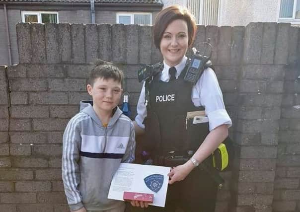 An officer representing the PSNI's Bogside, Brandywell and The Fountain Neighbourhood Team thanks Tiernan McCready for his courageous actions.