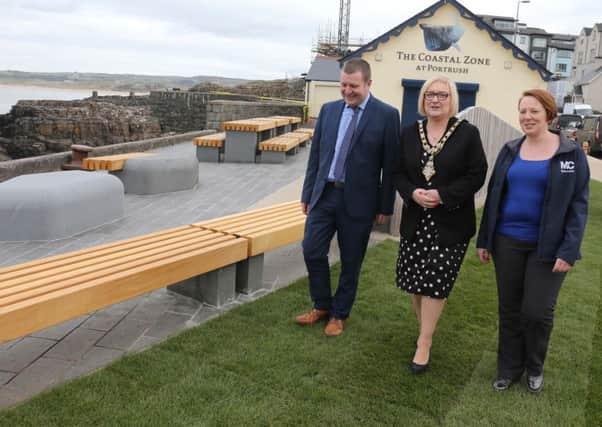 Ian McQuitty from the Department for Communities, Mayor of Causeway Coast and Glens Brenda Chivers, and Rebecca Henderson from contractor FP McCann, view some of the new paving and picnic benches