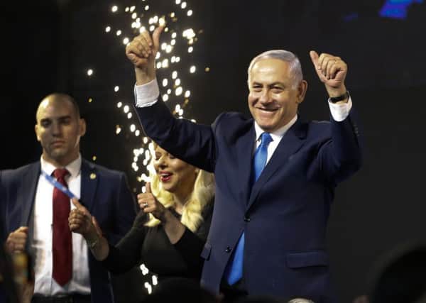 Israel's Prime Minister Benjamin Netanyahu waves to his supporters after polls for Israel's general elections closed in Tel Aviv, Israel, Wednesday, April 10, 2019. (AP Photo/Ariel Schalit)