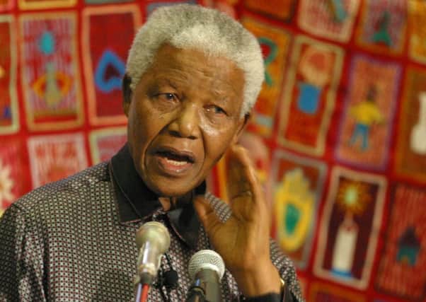 Former South African president Nelson Mandela at a World AIDS Day function in Bloemfontein, South Africa, in December, 2002. George McNally writes: "I witnessed the excesses of Apartheid in South Africa and followed the long struggle for political freedom as exemplified by Nelson Mandelas life."  (AP Photo/Benny Gool)