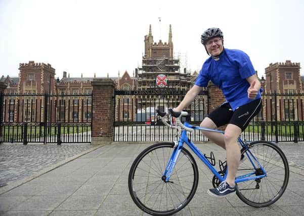 Rev Barry Forde, who is cycling the length of Ireland for charity,  outside Queen's in Belfast