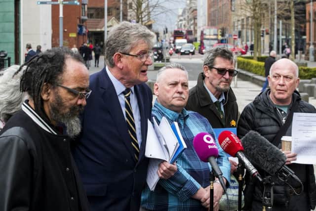 Jon McCourt (centre left) speaks to media accompanied by the victims and families of victims of historical institutional abuse outside Belfast's High Court, after a failed bid to force the Northern Ireland Secretary of State Karen Bradley to compensate those abused. Photo credit: Liam McBurney/PA Wire