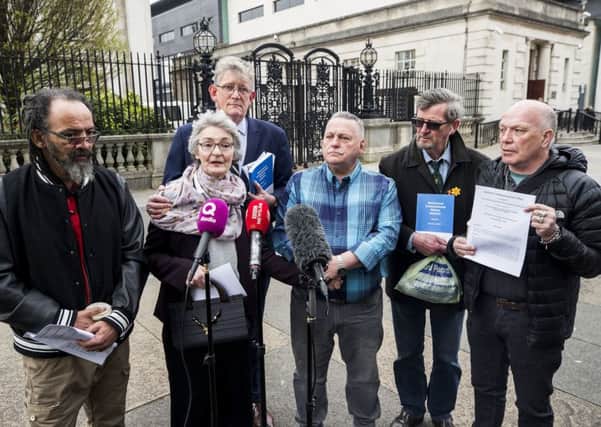 Kate McCausland (centre left) speaks of her mother Una Irvine outside Belfast's High Court with victims and families of victims of historical institutional abuse, after a failed bid to force the Northern Ireland Secretary of State Karen Bradley to compensate those abused. Photo credit: Liam McBurney/PA Wire