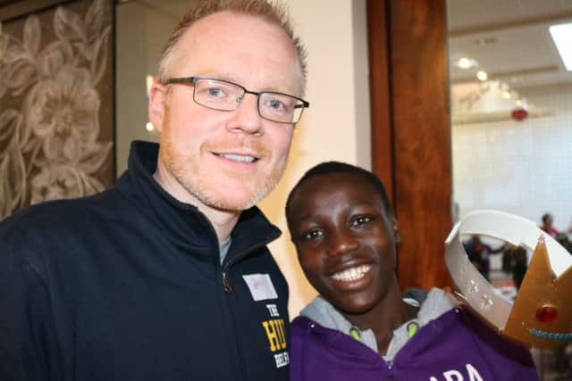 The Rev Barry Forde with Isaac, a member of the Abaana New Life Choir, which is sponsored by the Hub