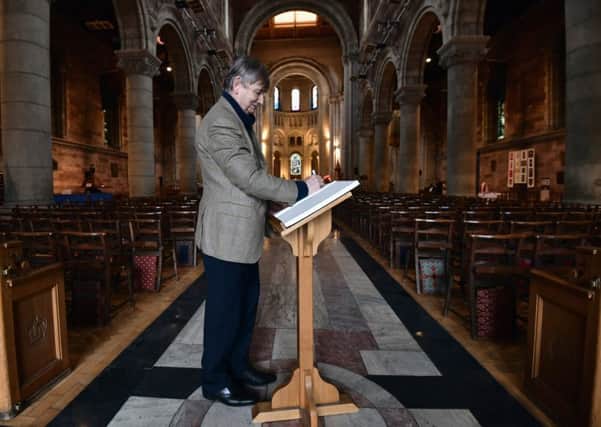 Signing the book of sympathy at Belfast Cathedral. Photo: Colm Lenaghan/Pacemaker Press