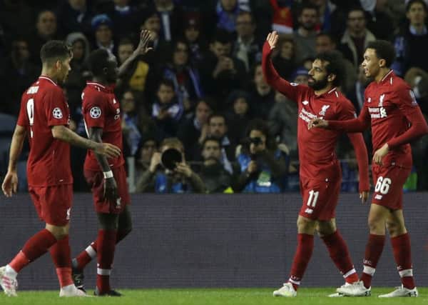 Liverpool's Mohamed Salah, second right, celebrates after scoring his side's second goal