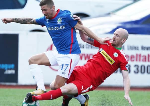 Cliftonvilles Ryan Catney (right) in action against Linfield