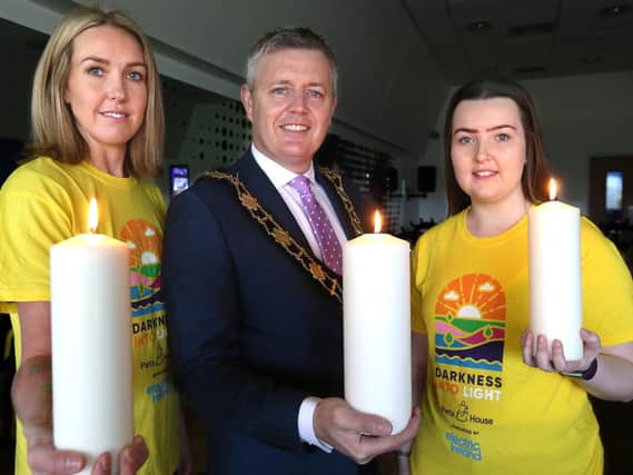 Mayor of Antrim and Newtownabbey, Councillor Paul Michael with Laura Campbell from Tesco Northcott and Chloe Erwin from Focus Group Antrim