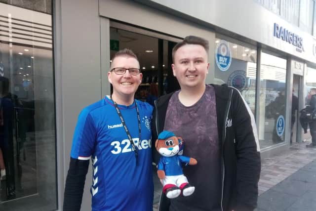 Store manager Alan Brown (left) with Rangers fan Stephen Nixon from east Belfast at the opening of the new store on Castle Lane
