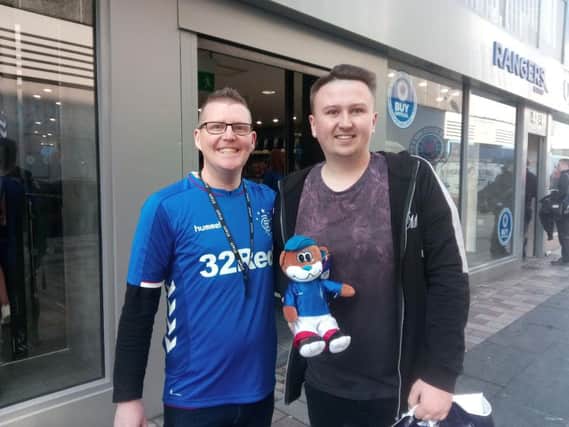 Store manager Alan Brown (left) with Rangers fan Stephen Nixon from east Belfast at the opening of the new store on Castle Lane