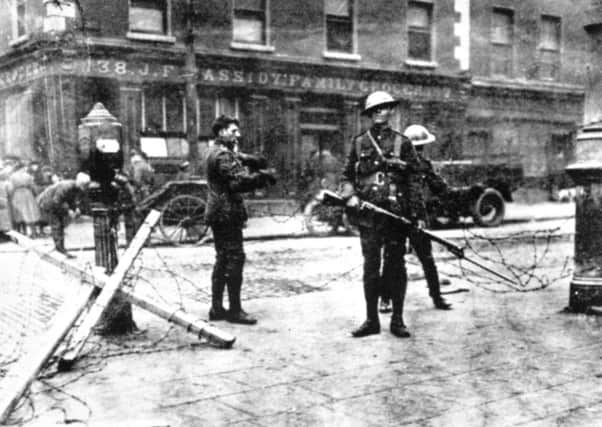 British troops man a road block outside Cassidy's grocery shop during the Easter Rising in Dublin, 1916.