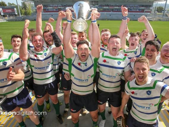 Grosvenor captain Andrew Kelly lifts the McCrea Cup as the players celebrate