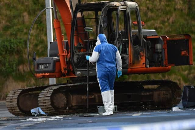 A forensics officer at the scene of the latest ATM theft, which occurred at a supermarket on Larne Link Road, Balllymena. Pic: Colm Lenaghan/Pacemaker