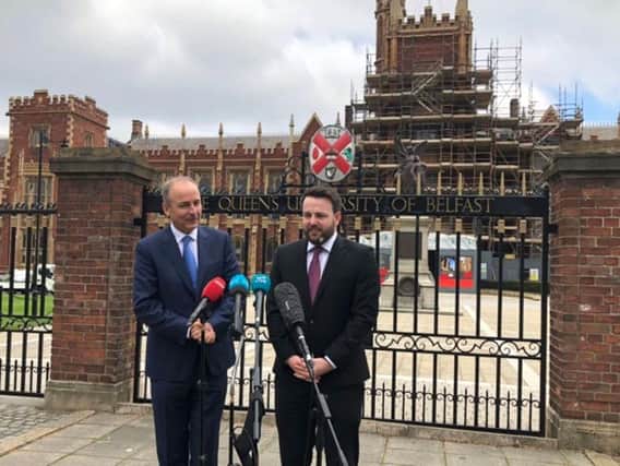 Micheal Martin and Colum Eastwood speaking outside Queen's University Belfast.