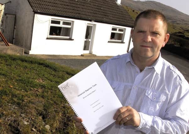 Samuel Heenan holds the Historical Enquiries Team summary report into his fathers murder, outside the family homestead near Castlewellan