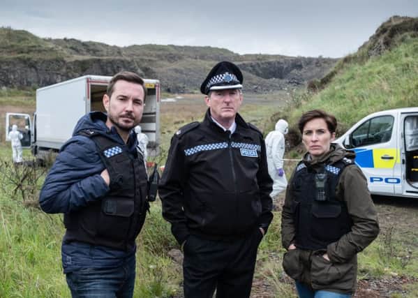 Steve (MARTIN COMPSTON), Hastings (ADRIAN DUNBAR), Kate (VICKY MCCLURE) on set in Northern Ireland. (C) World Productions - Photographer: Peter Marley