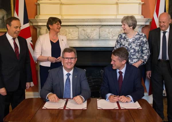 Jeffrey Donaldson sits with Gavin Williamson inside Downing Street, as they sign the confidence-and-supply agreement on June 26, 2017; they are flanked by Nigel Dodds and Arlene Foster (left) and Theresa May and Damian Green (right, the latter of whom resigned in December 2017)