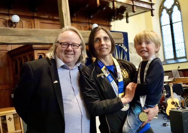Elite runner Gladys Ganiel attended a church service staright after finishing the Belfast Marathon. Also pictured are Rev Steve Stockman of Fitzroy Presbyterian and her son Ronan.
