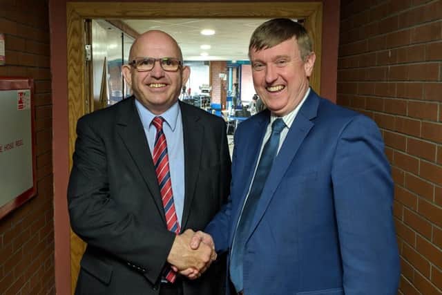 DUP MLA Mervyn Storey (right) congratulates party colleague John Finlay on holding on to his seat in Causeway Coast and Glens Council