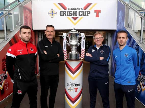 Crusaders captain Colin Coates, manager Stephen Baxter with Ballinamallard United manager Harry McConkey and captain Richard Clarke pictured with the Irish Cup at the National Football Stadium at Windsor Park.