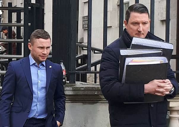 Carl Frampton (left) leaves the High Court with a member of his legal team after a date was set for his case against Barry McGuigan