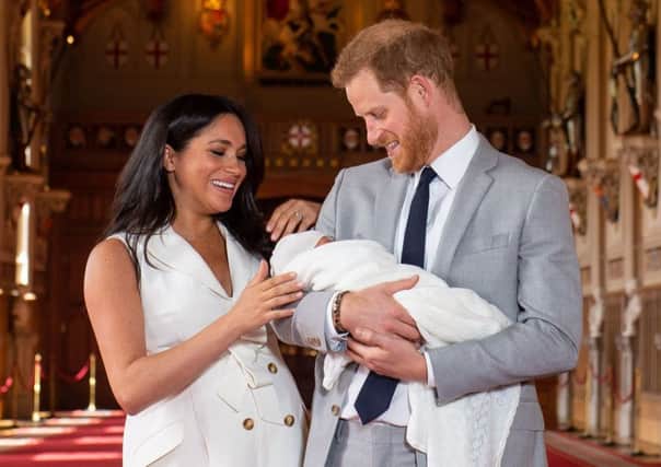The Duke and Duchess of Sussex with their baby son, who was born on Monday morning, during a photocall in St George's Hall at Windsor Castle in Berkshire