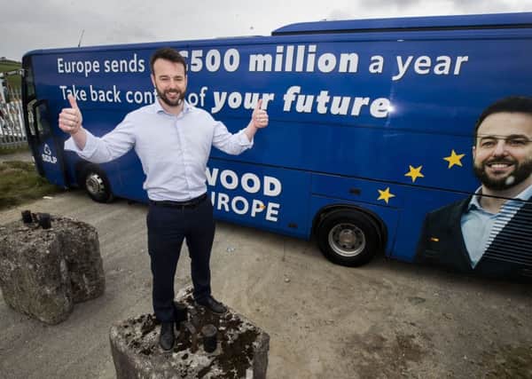 SDLP leader Colum Eastwood in front tof his election bus in Belfast. Photo: Liam McBurney/PA Wire