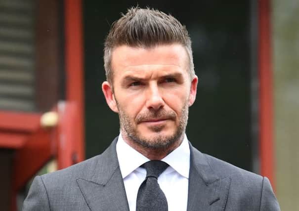 Football star David Beckham leaving Bromley Magistrates Court in south east London where he was disqualified for six months after receiving six points for using his mobile phone while driving his Bentley in London's West End.