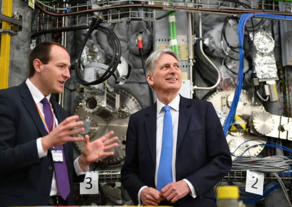 Chancellor Philip Hammond, right, speaking to UK Atomic Energy Authority CEO Ian Chapman, on the day of publication of the UK gross domestic product (GDP) first quarterly estimate