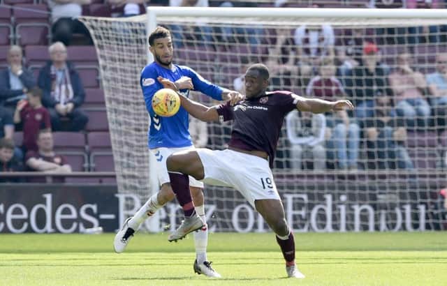 Rangers's Connor Goldson (left) and Hearts' Uche Ikpeazu battle for the ball during the Ladbrokes Scottish Premiership match at Tynecastle Stadium, Edinburgh. PRESS ASSOCIATION Photo. Picture date: Saturday April 20, 2019. See PA story SOCCER Hearts. Photo credit should read: Ian Rutherford/PA Wire. EDITORIAL USE ONLY