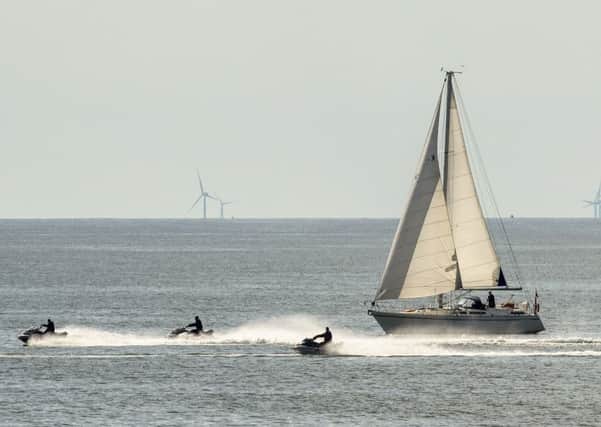 A boat and jet skiers enjoy the hot weather near Bridlington,  as temperatures are set to soar again following a week of bad weather. PRESS ASSOCIATION Photo. Picture date: Sunday May 12, 2019. Photo credit should read: Danny Lawson/PA Wire