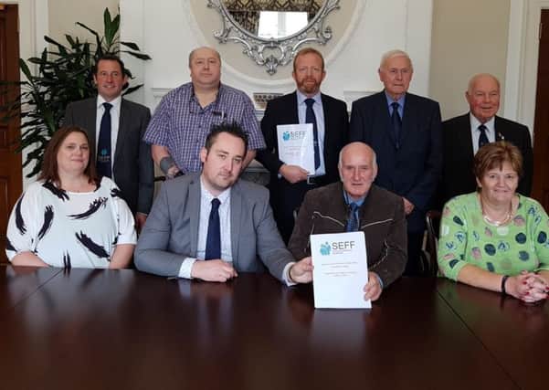 Kenny Donaldson of Innocent Victims United, front row second from left, and Ken Funston, back row centre, of South East Fermanagh Foundation (SEFF), with representatives of various victims groups presenting a response to the legacy consultation at Stormont House  last September