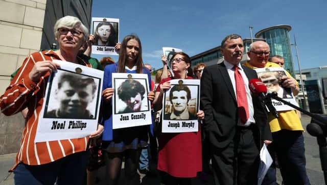 John Teggart (second right), whose father Danny was shot dead in Ballymurphy, speaks to the media outside Belfast Coroner's Court, alongside other bereaved relatives
