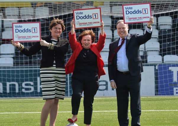 Arlene Foster , Diane Dodds and Nigel Dodds on the pitch at Seaview after yesterdays manifesto launch