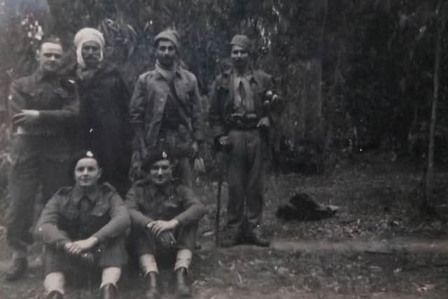 Dave Mullin (front left) with three fellow soldiers and three locals in Tunisia in July 1943