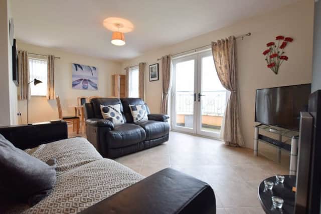 The apartment features a large open plan kitchen/living space with access onto a private balcony overlooking the Bay.