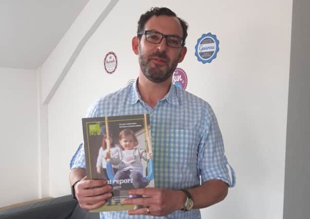 Paul Livingstone, partnership manager, CAP Northern Ireland, with a copy of the charity's Changing Perceptions report.
