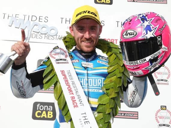 Lee Johnston celebrates his victory in the Supersport race at the North West 200 on Thursday. Picture: Stephen Davison/Pacemaker Press.