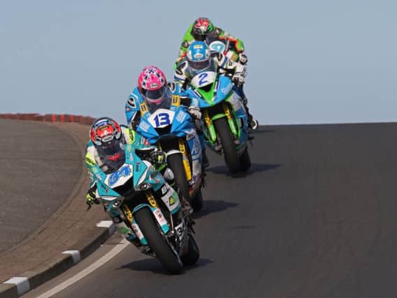 Alastair Seeley leads Lee Johnston in the Supersport race at the North West 200 prior to his last lap crash on Thursday.