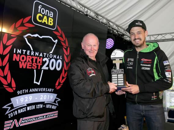 James Hillier receives the Robert Dunlop trophy from North West 200 Event Director, Mervyn Whyte.