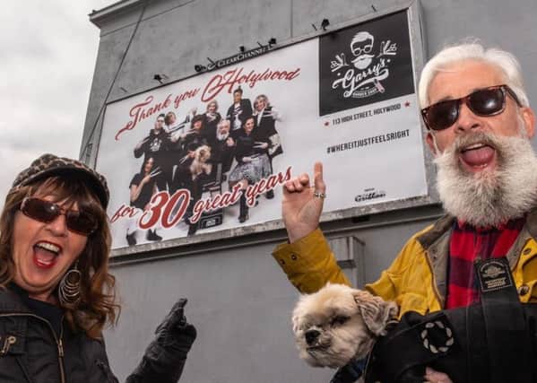 Garry Jackson with wife Mari with the anniversary billboard in Holywood