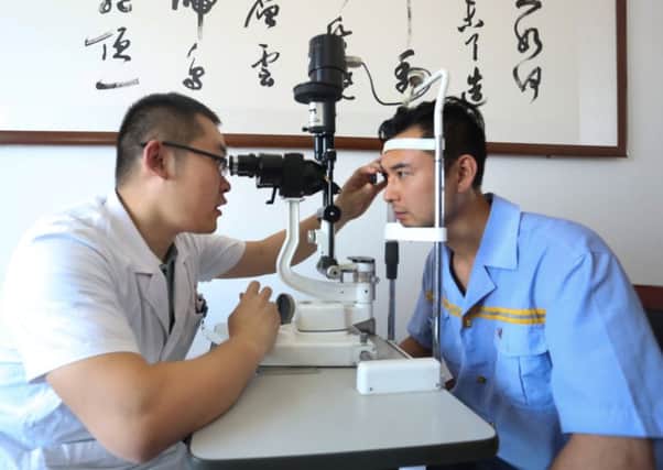 A man getting a glaucoma screening test in China from an ophthalmologist