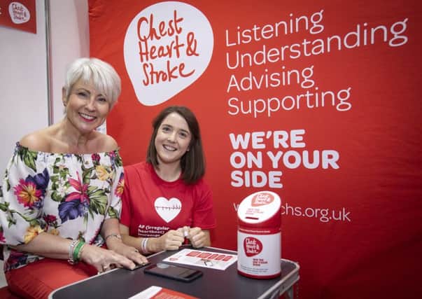 Pamela Ballantine takes the AF test with Hannah Williamson, senior health and wellbeing officer, Northern Ireland Chest Heart and Stroke.